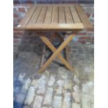 A hardwood folding garden table - Height 76cm x 65cm x 65cm