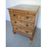 A walnut three drawer chest with a brushing slide on bracket feet - Height 75cm x 60cm x 47cm