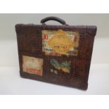 A good early 20th century vintage crocodile suitcase with a fitted green leather interior with two