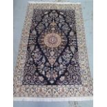 A hand knotted woolen fine Nain rug - 1.95m x 1.24m - in good condition