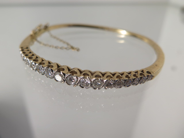 A 9ct yellow gold 18 stone diamond hinged bracelet 6cm x 5.5cm external - approx weight 15.4 grams -