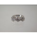 An 18ct white gold three stone ring - the centre diamond approx 1.20ct flanked by approx 1.00ct