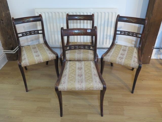 A set of four Regency faux rosewood sabre leg dining chairs with brass inlay - Height 81cm - some