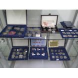 A collection of assorted proof coins and bank notes