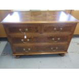 A re veneered walnut star inlaid four drawer chest on bun feet - in good condition and colour -