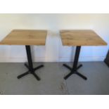 A pair of new wooden top café tables on steel bases - Height 75cm x 50cm x 60cm