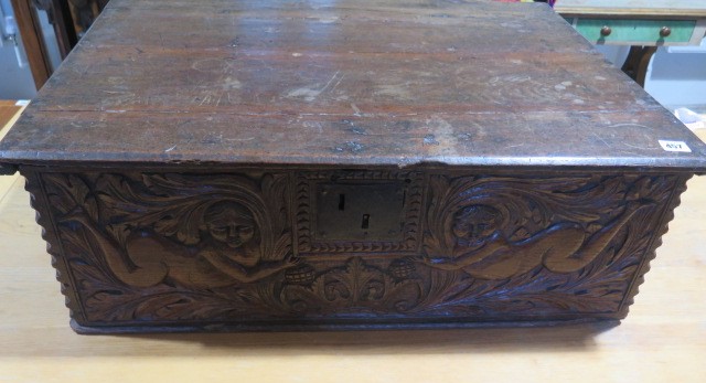 An 18th century oak box with a carved figural and crown front panel - Height 26cm x 79cm x 58cm