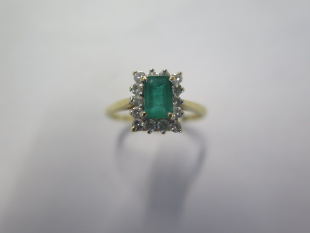 A hallmarked 18ct yellow gold Emerald and diamond ring size P, head approx 9.7mm x 8.6mm - approx