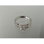 A good quality 950 platinum three stone diamond ring with a central cushion cut diamond, carat