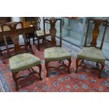 A set of of three marquetry inlaid side chairs with needlepoint seats and shaped stretchers -