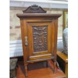 A late 19th century walnut bedside cabinet with a label for Hampton & Sons London