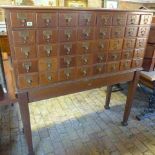 An oak bank of 40 library index drawers on a stand by Libraco London - Height 143cm x 135cm x 53cm