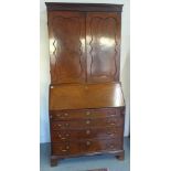 A Georgian mahogany bureau bookcase - the top with two doors over the base with a well fitted