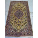 A hand knotted woolen Kashan rug - 2.08m x 1.16m - in good condition