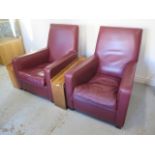 *A pair of maroon leather cinema armchairs with walnut veneer cupholder side tables - apparantly
