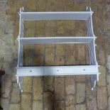 A three tier painted wall shelf with fretwork sides and three drawers 92 cm tall x 75 x 21