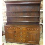 An 18th century oak dresser with an open rack top above a six drawer two door base with a good