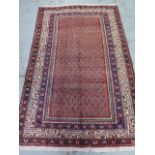 A hand knotted woolen Araak rug - 2.05m x 1.30m - in good condition
