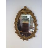 A 20th century ornate gilt wall mirror - 62cm x 46cm