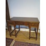 An unusual Chinese hardwood freestanding three drawer side table on turned supports in three