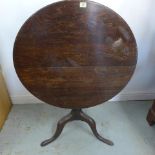 A Georgian tilt top side table with an oak tripod base