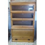 An oak Globe Wernicke stacking bookcase with three glazed sections and one base section with a solid