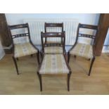 A set of four Regency faux rosewood sabre leg dining chairs with brass inlay - Height 81cm - some