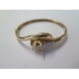A 9ct yellow gold leopards head hinged bangle set with small diamonds - 6.5cm x 6cm external -