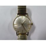 A 9ct yellow gold Rotary manual wind gents wristwatch with a 34mm case on a sprung strap, running,