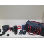 A Canon T70 35mm SLR camera, Canon 50mm lens, Canon 28mm lens and Canon 100-200mm lens with two