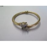 A 9ct yellow gold sprung hinged bangle with leopard heads - approx weight 17.3 grams