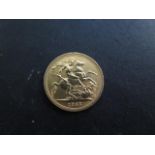 An Elizabeth II gold full sovereign coin dated 1965