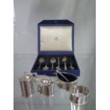 A silver three piece cruet, a silver napkin ring and six silver spoons - boxed - total silver approx