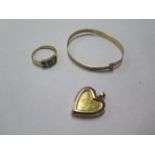 A gilt metal child's bangle, a gilt ring and a gold on silver locket - total weight approx 9.4 grams