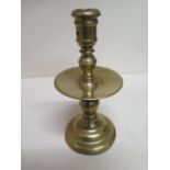 An 18th century brass candlestick with drip tray - Height 20cm