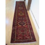 A hand knotted woollen Karajeh rug - 4.35m x 0.90m