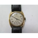 A 9ct yellow gold gents manual wind gents wristwatch with 29mm case on a leather strap - running,