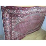 A hand knotted woollen Araak rug - 1.98m x 1.26m