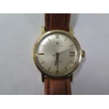A gold Hamilton automatic gents wristwatch with date - 33mm case - on a leather strap, running,