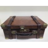 A good quality leather and brass cartridge case with wooden interior - in good polished restored