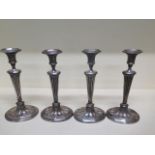 A set of four Sheffield plate candlesticks - Height 31cm - some wear to plate otherwise generally