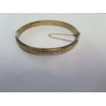 A hallmarked 9ct yellow gold bangle - 6.5cm x 6cm external - approx weight 8.2 grams