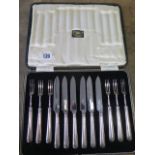 A boxed set of six silver handle cake forks and knives