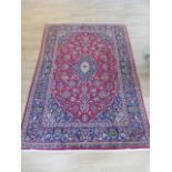 A hand knotted woollen Kashan rug - 2.10m x 1.40m