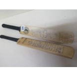 Two autographed mini cricket bats signed by England, New Zealand and South Africa teams, the first