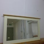 A painted wall mirror - 64cm x 104cm