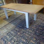 A Neptune style shaker dining room table with an oak top with a fold away leaf and painted legs