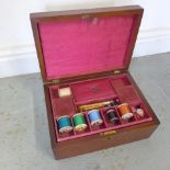 A fitted mahogany sewing box with contents - Width 28cm