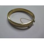 A 9ct yellow gold bark effect hollow bangle - 6.5cm x 5.5cm external - approx weight 13.2 grams -