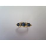 A hallmarked 18ct yellow gold sapphire and diamond ring size M - approx weight 4.7 grams - generally